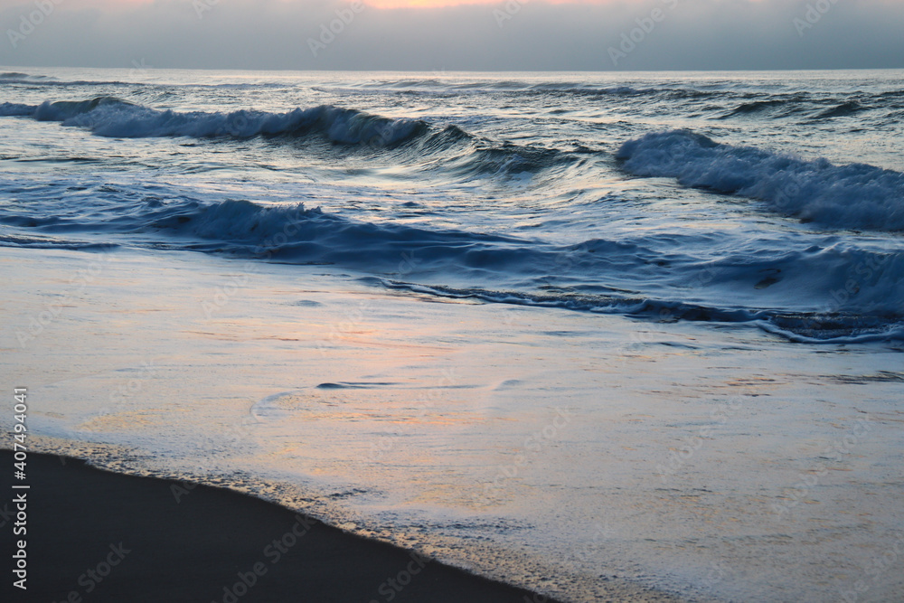 Cloudy sunset over the ocean and a little beach Cloudy sunset over the ocean and a little beach