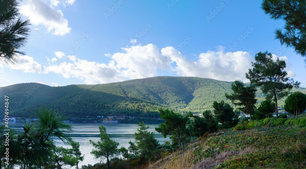 Mountains and azure Aegean sea on a bright sunny day. Travel to Turkey. Beautiful seascape. Panorama.