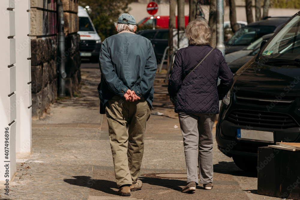 Old Couple from behind, An old couple is walking in the spring, photographed from behind