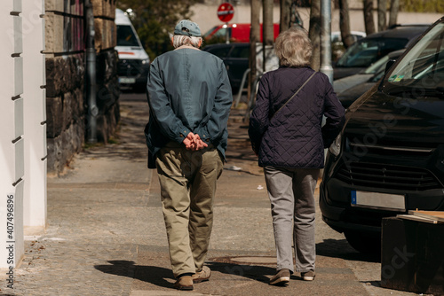 Old Couple from behind, An old couple is walking in the spring, photographed from behind