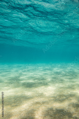 Underwater shallow ocean with sand and blue water