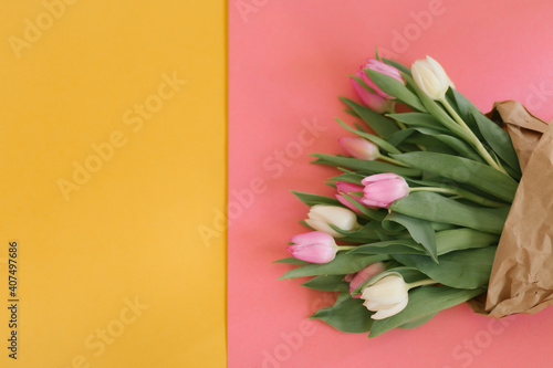 Tulips on pink and yellow for a Womens Day, Mother Day, 8 march or Valentines day. The concept of holidays and good morning wishes.