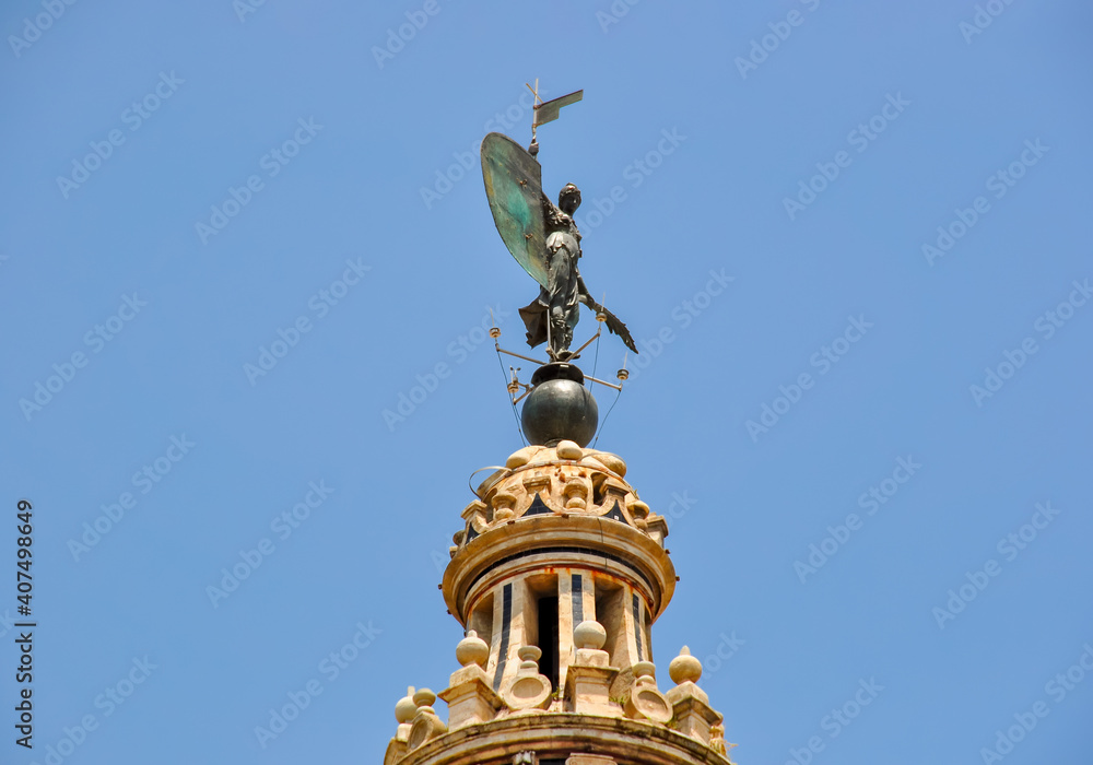 Statue on top of Giralda tower of Seville cathedral, Spain