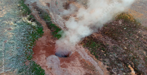 Drone view looking down onto geothermal steam vent in the Nevada Desert. photo