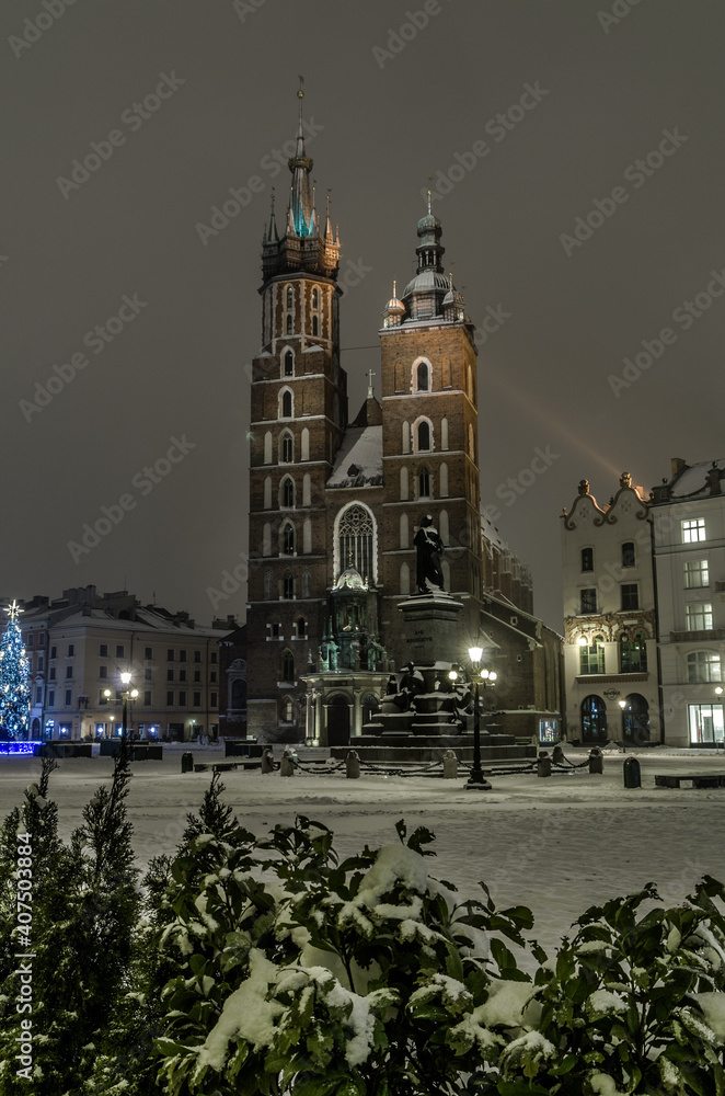 Winter night in Cracow marketplace, view to St. Mary's Church