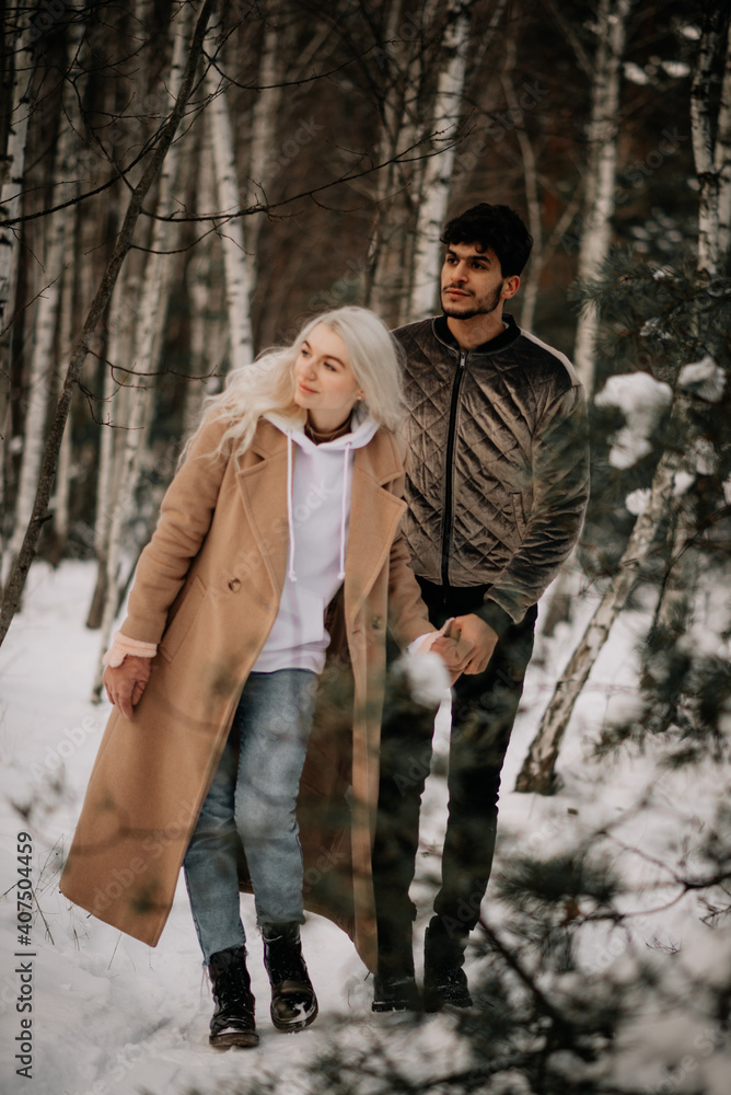 couple walking in winter forest couple walking in winter forest