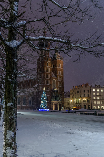 Winter in Cracow, snowy night near St. Mary's Church in Cracow marketplace