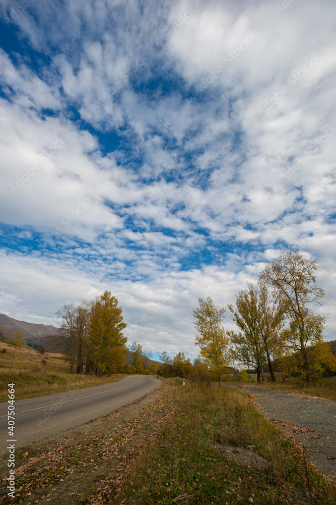 Beautiful autumn landscape with road anf fabulous clouds, Armenia
