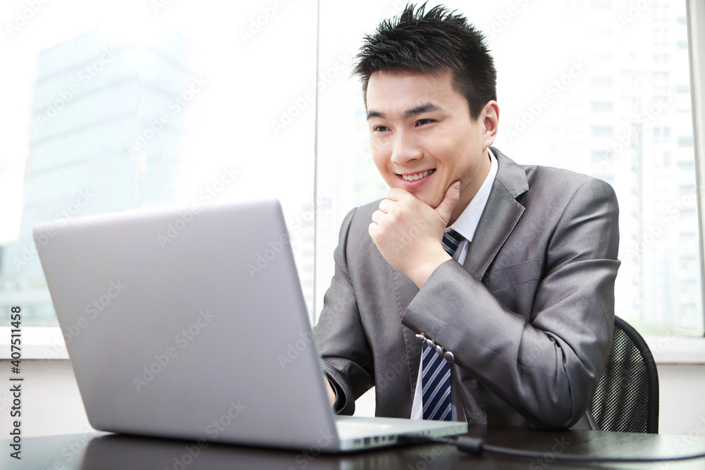 Portrait of Businessman using laptop in office Portrait of Businessman using laptop in office
