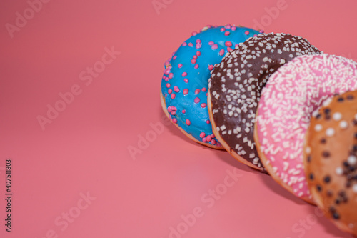 Sweet delicious donuts on a pink background