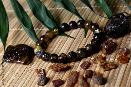 raw amber and amber in products on a natural background