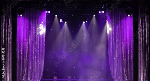 An empty stage of the theater, lit by spotlights and smoke before the performance	