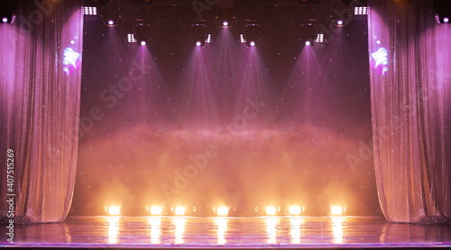 An empty stage of the theater, lit by spotlights and smoke before the performance	