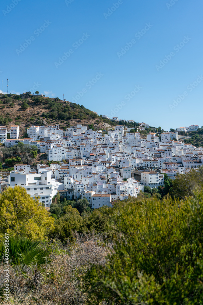 Typical spanish mountain village with its narrow white buildings in Andalusia