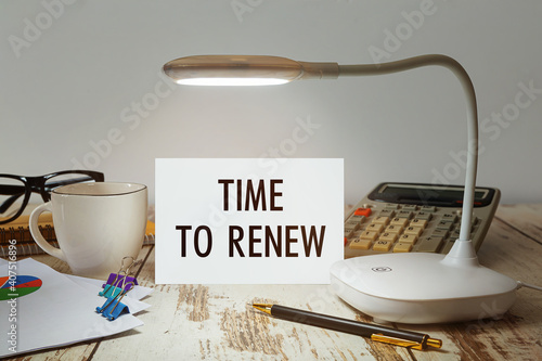 Desktop with a lamp that illuminates the inscription Time to RENEW