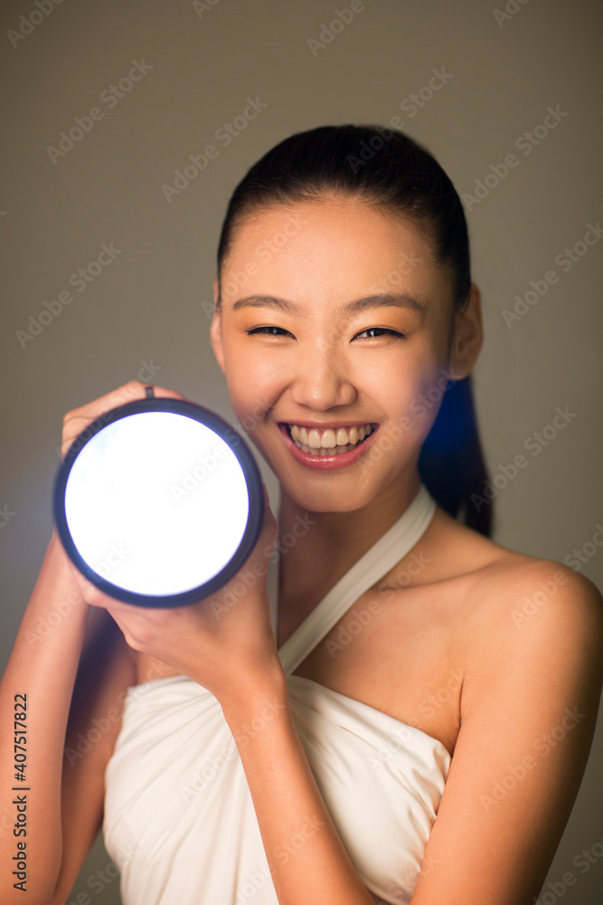 Young woman holding a flashlight Young woman holding a flashlight