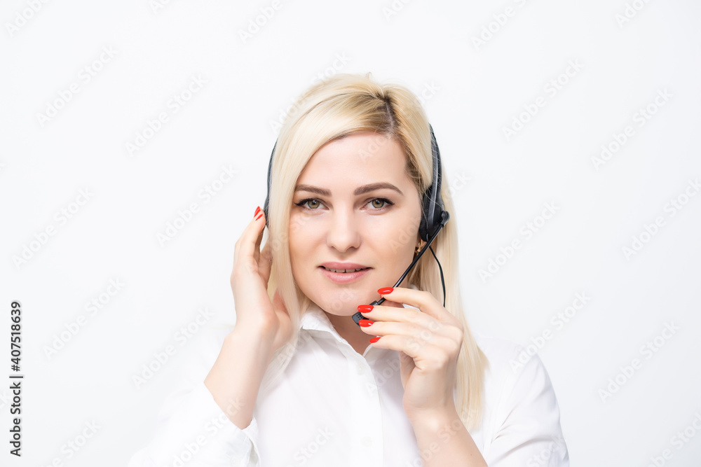 Young businesswoman in headphones working on a laptop at office Young businesswoman in headphones working on a laptop at office