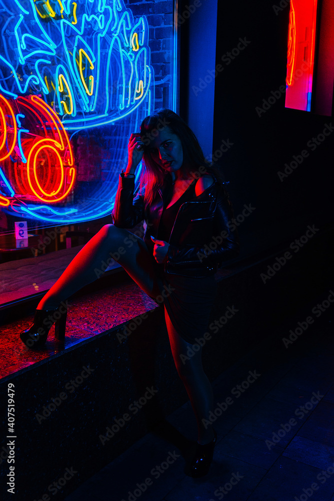 Girl in neon color walking in the night city Girl in neon color walking in the night city