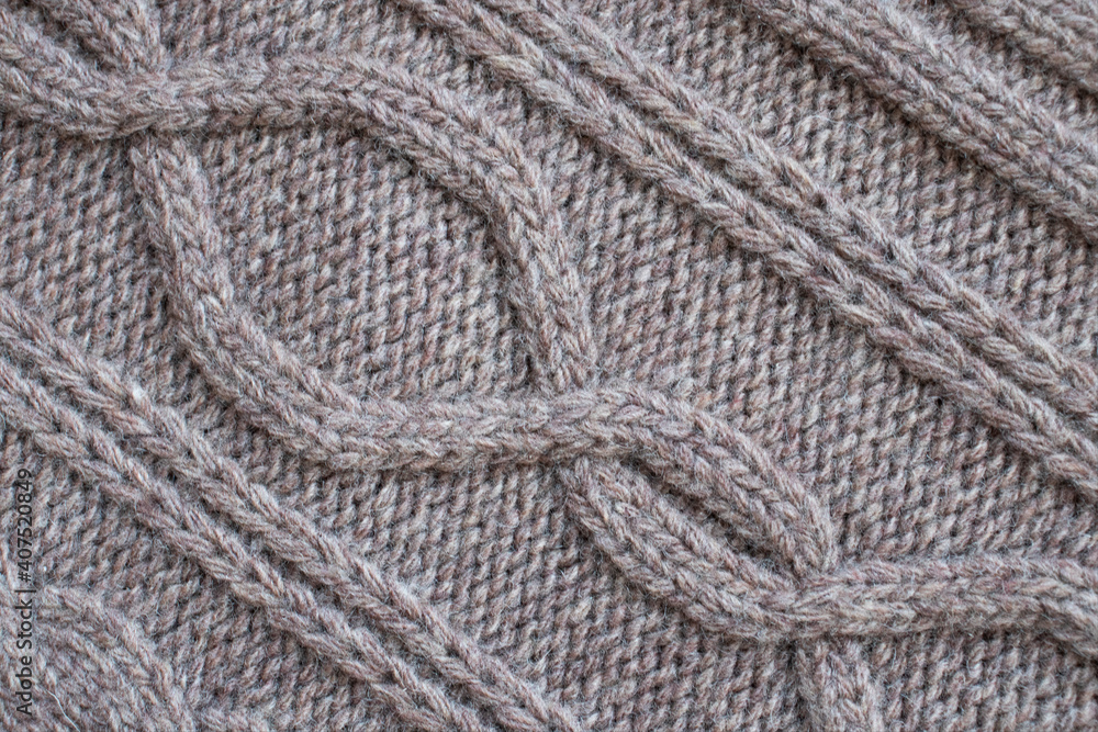 Seamless knitted fabric with pigtails. Knitted sweater, plaid, scarf. Knitted background Seamless knitted fabric with pigtails. Knitted sweater, plaid, scarf. Knitted background