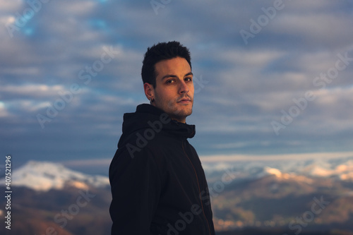 Young hiker at the top of a snowy mountain on winter. photo