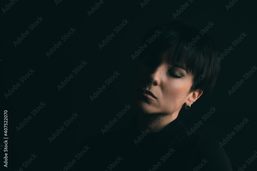 Portrait of an attractive woman with her eyes closed in studio Portrait of an attractive woman with her eyes closed in studio