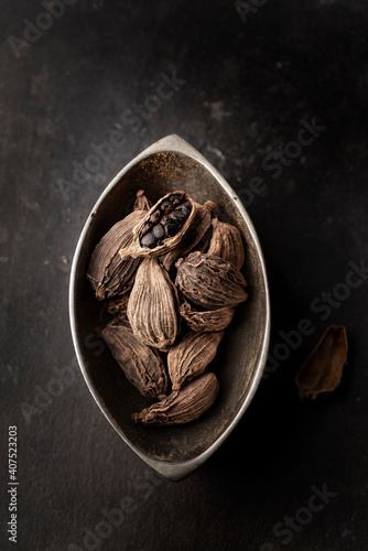clack cardamom seed and pod - close up macro 