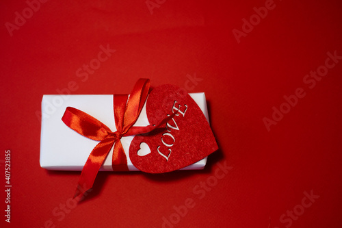 Banner. Velentines Day. Flat red heart, white handmade gift boxes on a red background. Copy space. Holidays and love concept photo