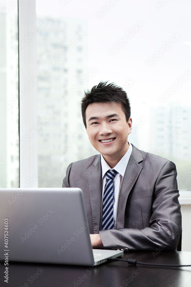 Portrait of Businessman using laptop in office Portrait of Businessman using laptop in office