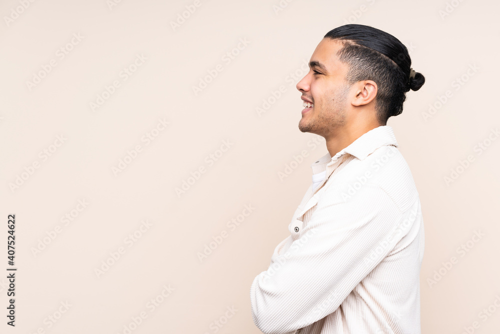 Asian handsome man over isolated background in lateral position Asian handsome man over isolated background in lateral position
