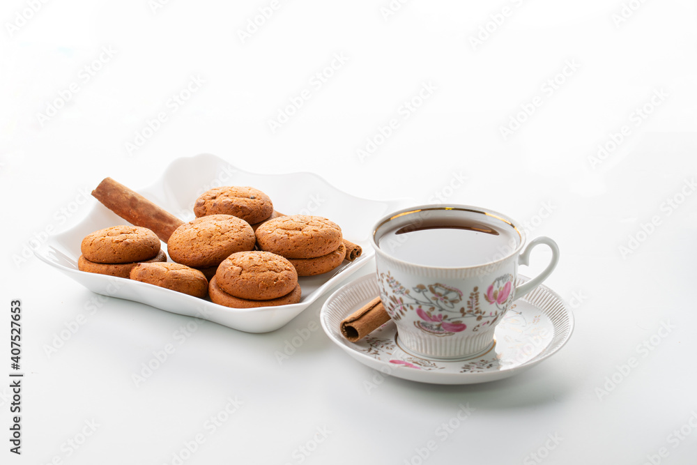 cup of hot tea cinnamon cookies selective focus on white background high key cup of hot tea cinnamon cookies selective focus on white background high key