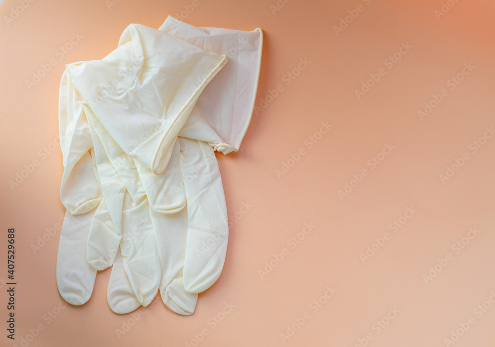 Obraz premium light, rubber, disposable gloves on a yellow background, close-up