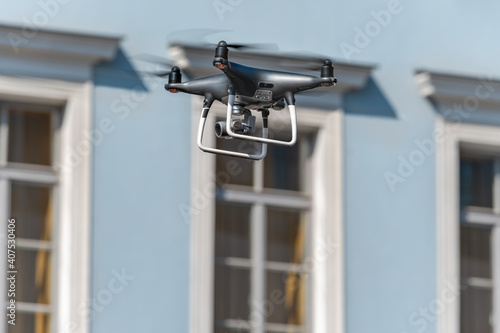 Drone on the background of windows. The concept of surveillance, espionage, information gathering, invasion of privacy