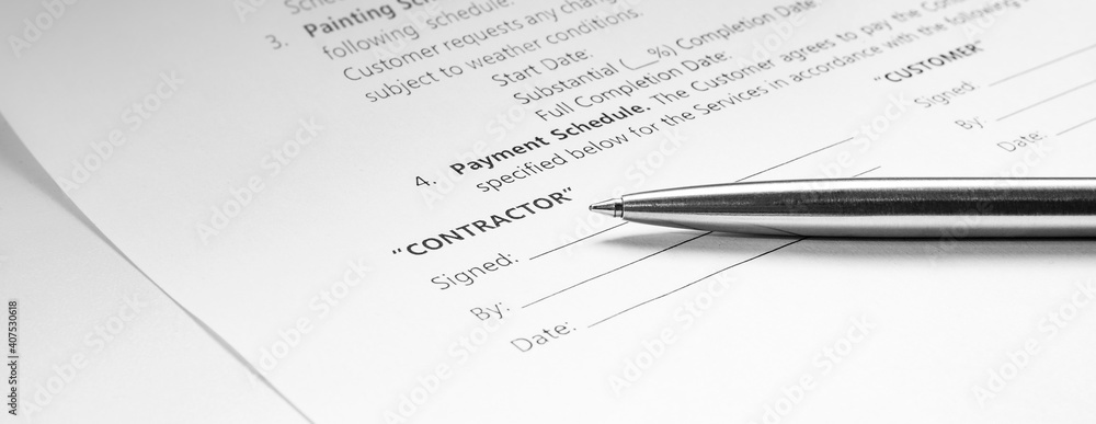 Obraz premium Close-up of a silver pen on docunent contract. Legal contract signing. Buy sell real estate contract agreement. Customer sign on document paper with silver pen