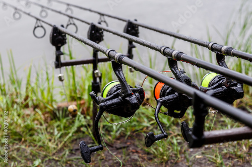 Carp spinning reel angling rods on pod standing. Carp Rods,Carpfishing session at the Lake.Professional fishing equipment