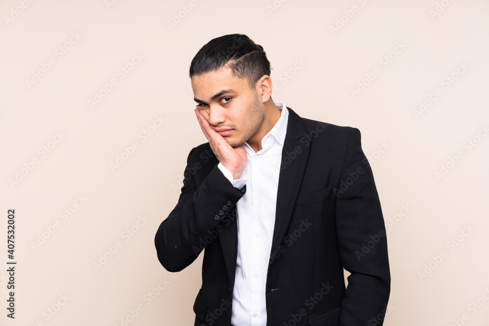 Asian business man isolated on beige background unhappy and frustrated Asian business man isolated on beige background unhappy and frustrated
