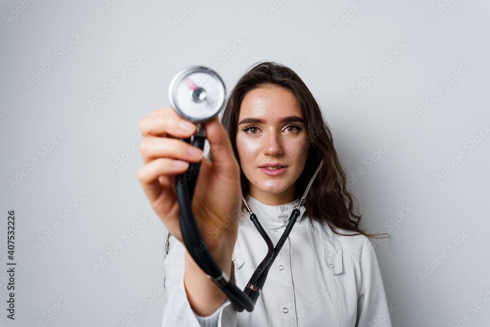 Fototapeta premium Medical student girl doing auscultation to patient. Doctor uses phonendoscope for auscultation. Medical therapy and treatment