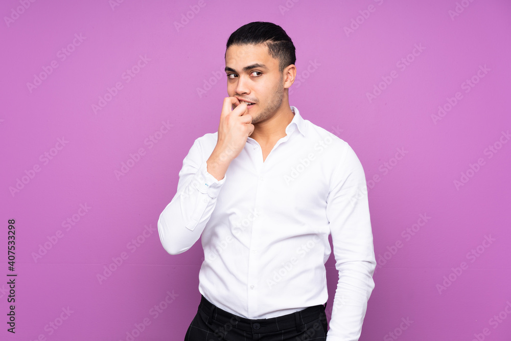 Asian handsome man isolated on blue background nervous and scared Asian handsome man isolated on blue background nervous and scared