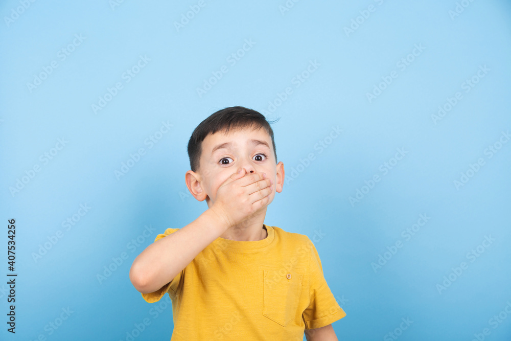 Surprised little boy covered his mouth with his hand Surprised little boy covered his mouth with his hand