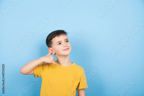 child imitates a telephone conversation, makes a telephone call gesture with his or his hand