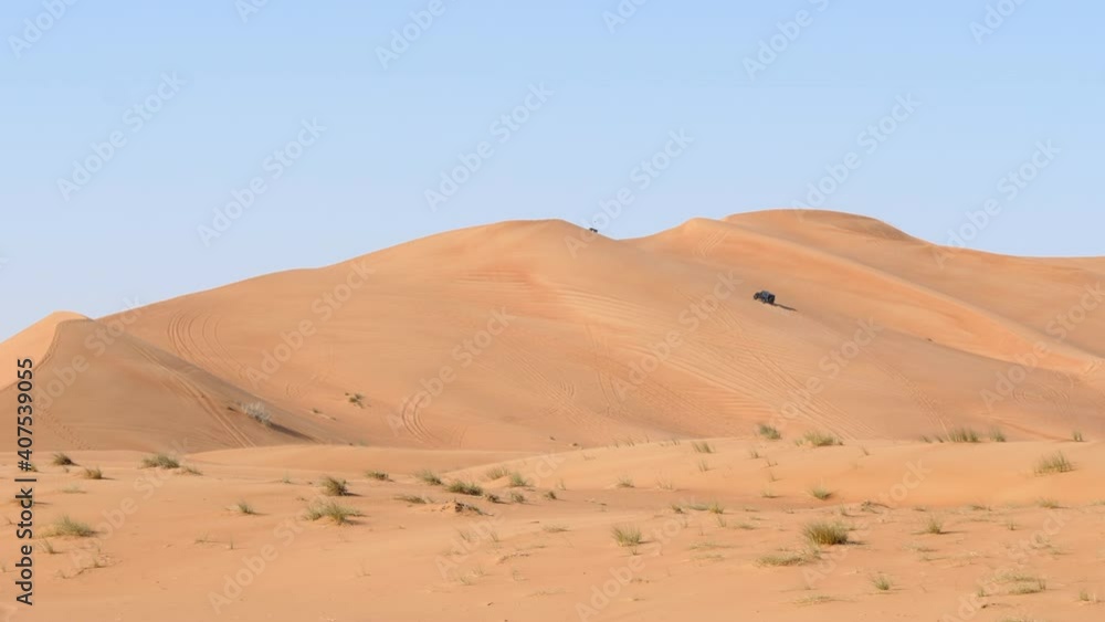 Two 4x4 SUVs on an off road safari in the desert dune bashing in Dubai Two 4x4 SUVs on an off road safari in the desert dune bashing in Dubai
