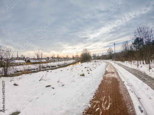 Sunny view of cycling and walking path on Radunia canal at winter time in Pruszcz Gdanski. © Robson90