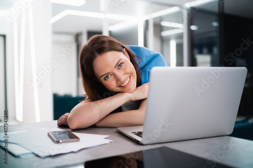 Portrait of gamer girl playing online game on a laptop from home