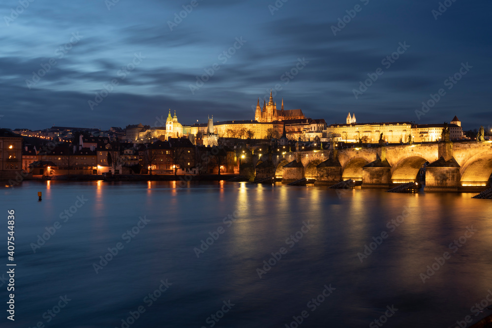 .panoramic view of Charles Bridge on the Vltava river and in the background Prague Castle and St. Vitus Cathedral in the center of Prague in the evening