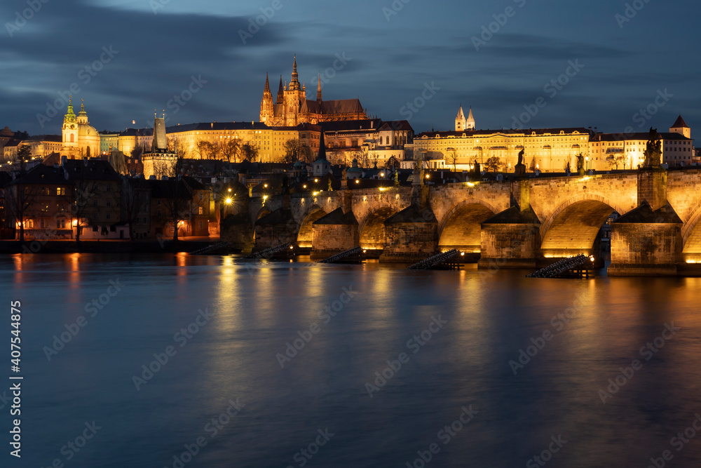 .panoramic view of Charles Bridge on the Vltava river and in the background Prague Castle and St. Vitus Cathedral in the center of Prague in the evening