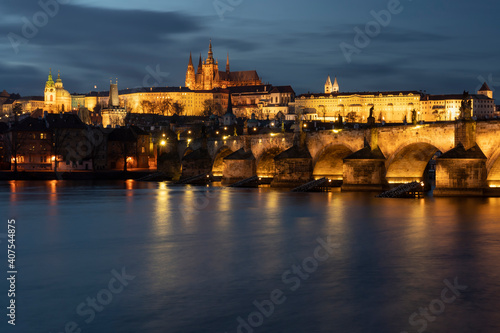 .panoramic view of Charles Bridge on the Vltava river and in the background Prague Castle and St. Vitus Cathedral in the center of Prague in the evening © svetjekolem