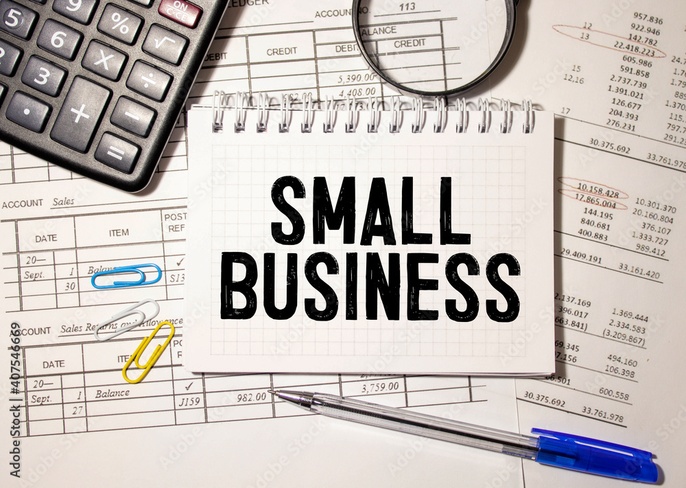 Small Business Conceptual background with calculator and papers Small Business Conceptual background with calculator and papers