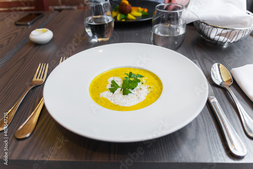 Obraz na plátně Beautiful professional close up of a gourmet soup with cream and herbs