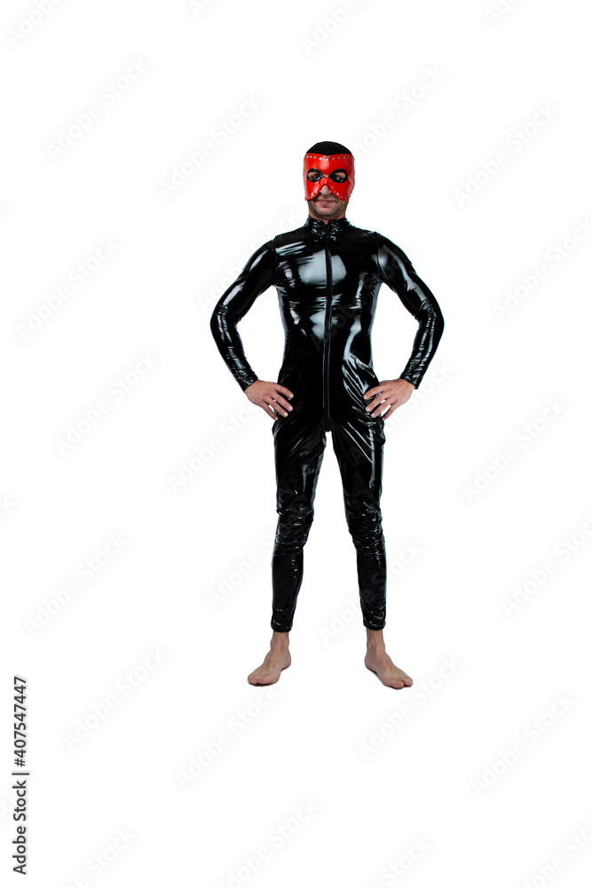 Adult kinky man dressed in fetish latex rubber costume with black red pvc mask isolated on white background. Caucasian man dressed in fashionable latex rubber fetish clothes. fetish man in black mask Adult kinky man dressed in fetish latex rubber costume with black red pvc mask isolated on white background. Caucasian man dressed in fashionable latex rubber fetish clothes. fetish man in black mask