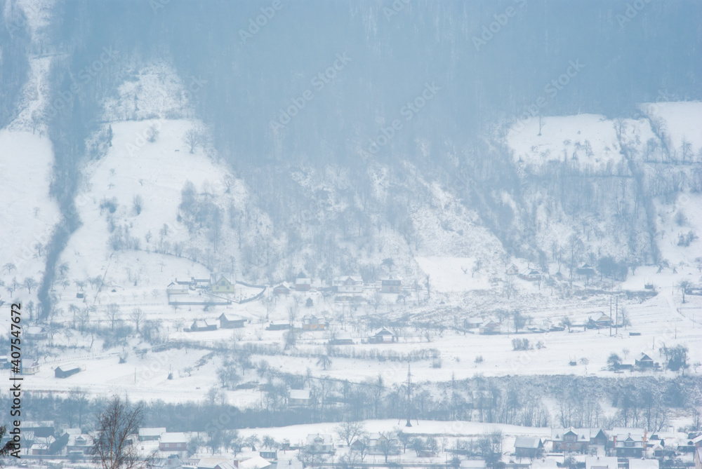Misty winter morning in mountain village