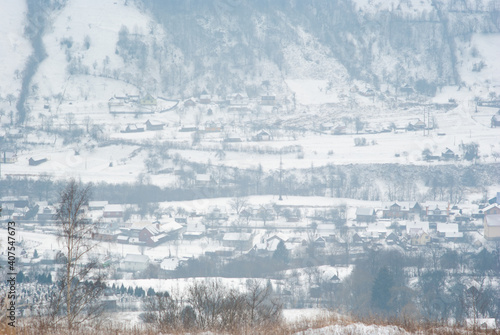 Misty winter morning in mountain village © onyx124